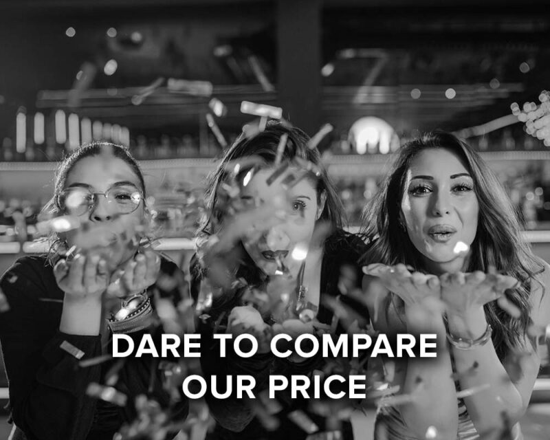 dare to compare our price, women blowing confetti off their hands