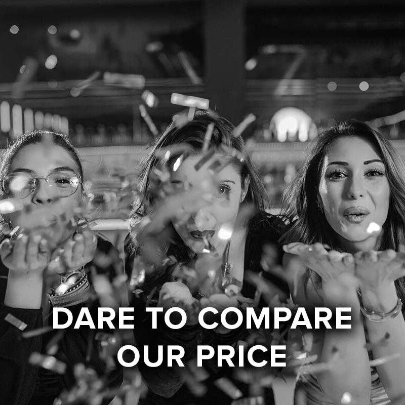 dare to compare our price, women blowing confetti off their hands