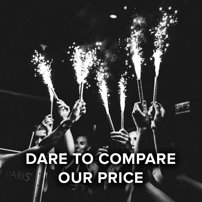 dare to compare our price, group raising sparklers in celebration